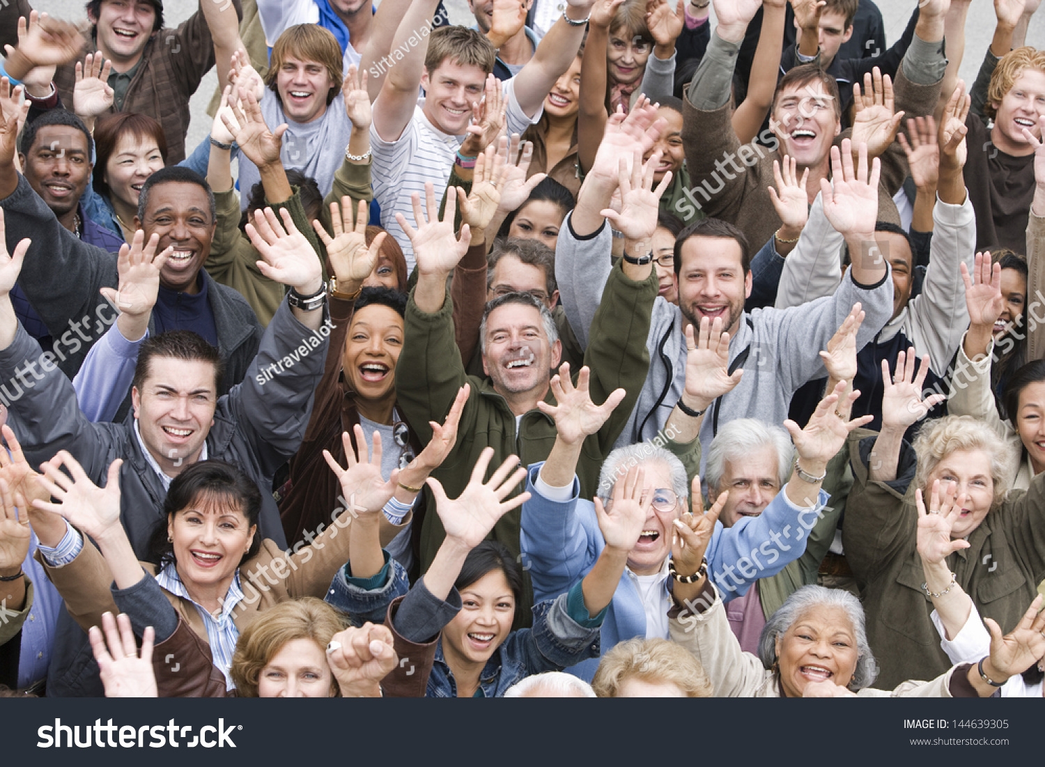 High Angle View Of Group Of Happy Multiethnic People Raising Hands 